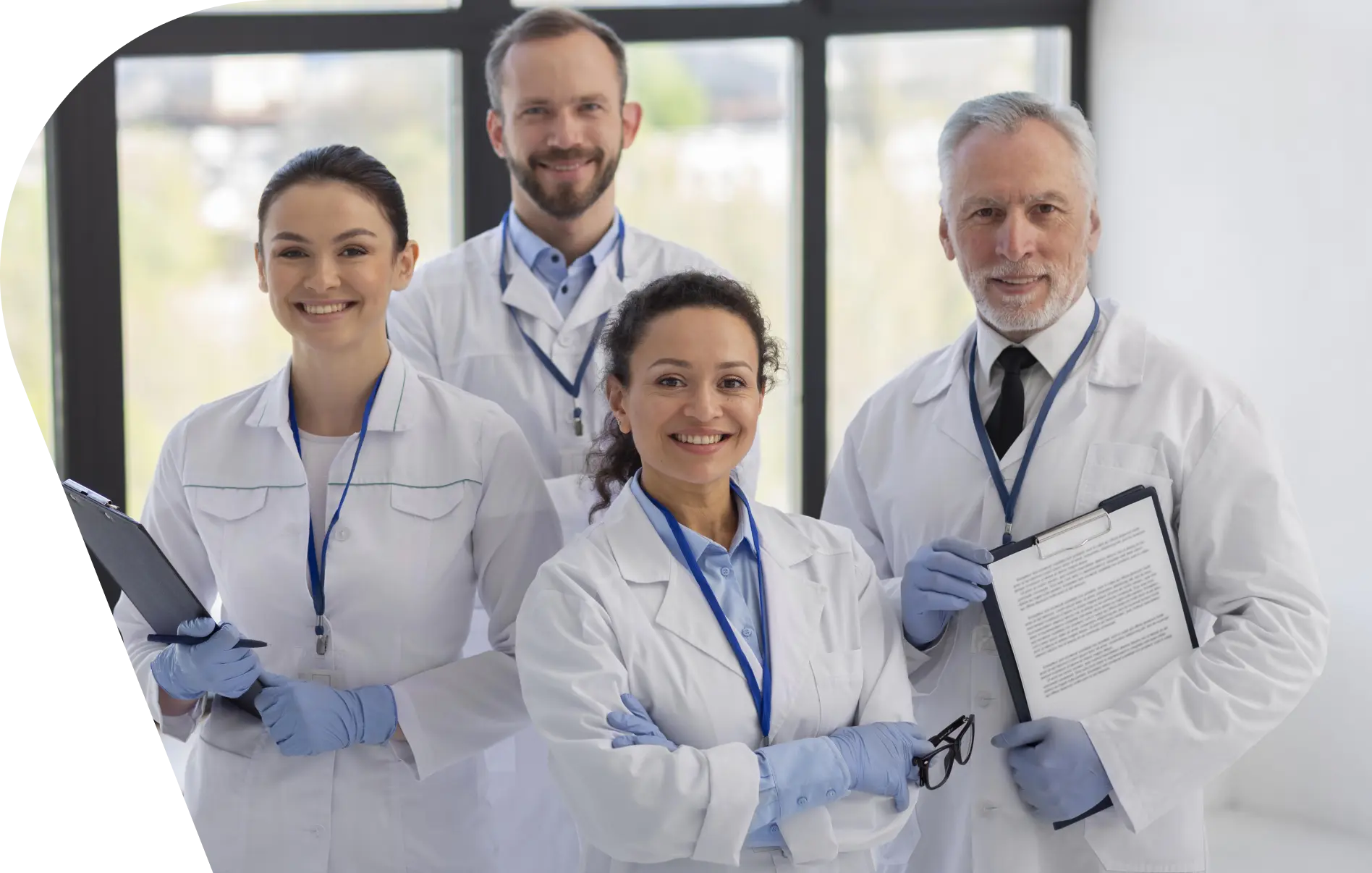 GettyImages-1345126530 (1) A group of doctors standing in front of a window.