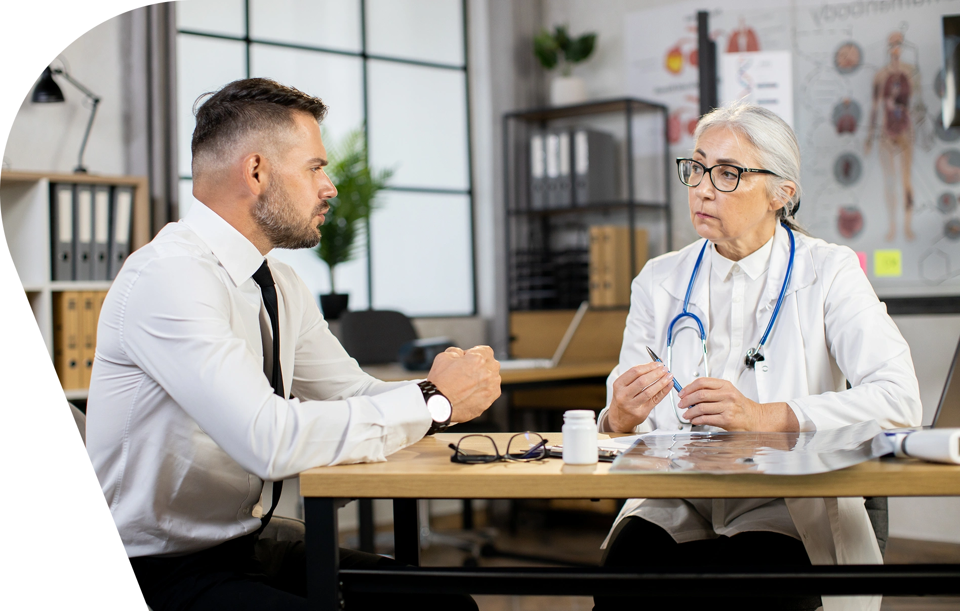 A man and woman sitting at a table talking.