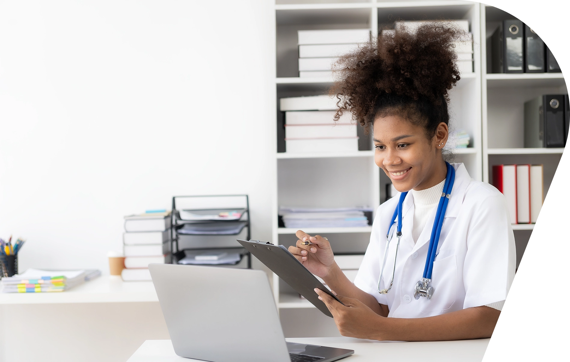 A woman sitting at a table with a laptop.